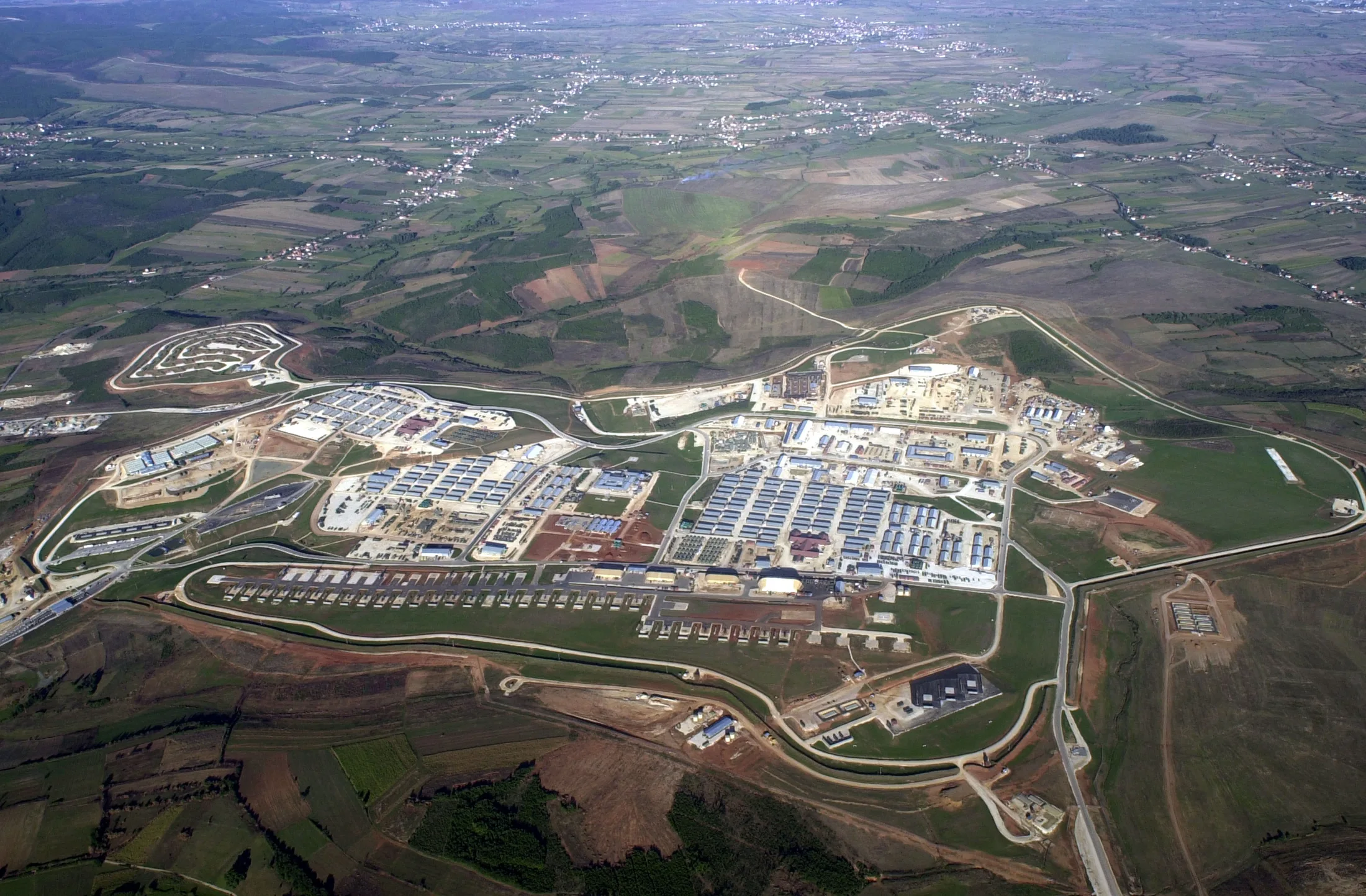 Aerial view of Camp Bondsteel with accommodation blocks, internal roads and shared facilities