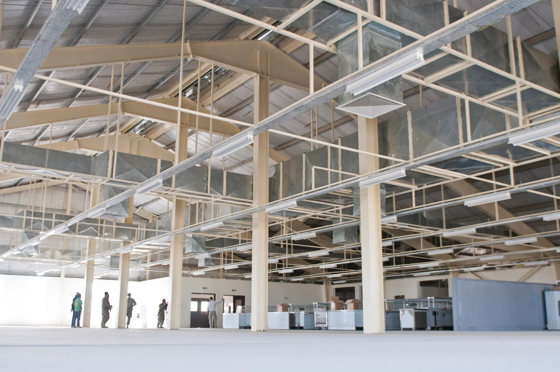 Steel roof structure and ventilation ducts inside the Super FOB dining facility during construction